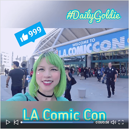 Это скриншот видео Goldie Chan на LinkedIn со стартовым экраном. Видео было снято на смартфон горизонтально и превратилось в квадратное видео с размытым шрифтом сверху и снизу. На начальном видеоизображении Голди изображена перед конференц-центром LA Comic Con. Голди появляется с плеч вверх. Она азиатка с зелеными волосами. На ней косметика, черное колье-чокер и бирюзовая рубашка. В области почтового ящика над видео светло-зеленым шрифтом с бирюзовым контуром отображается #DailyGoldie. Значок «Нравится» в LinkedIn с номером 999 появится в синем поле над головой Голди. В области почтового ящика под видео текст «LA Comic Con» отображается светло-зеленым шрифтом без засечек с бирюзовым контуром.